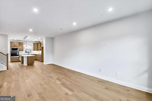 unfurnished living room featuring light hardwood / wood-style flooring