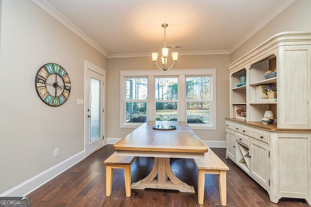 dining room featuring dark hardwood / wood-style floors, crown molding, and a notable chandelier