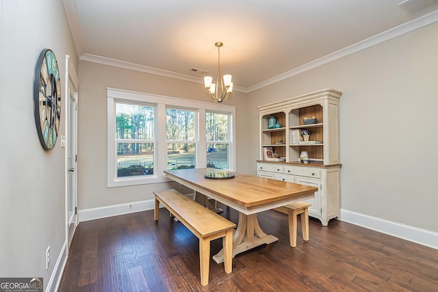 dining area with crown molding, dark wood-type flooring, and a chandelier