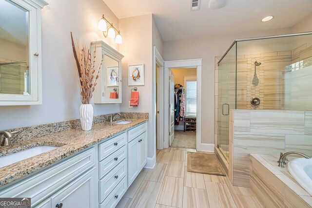 bathroom featuring vanity and separate shower and tub