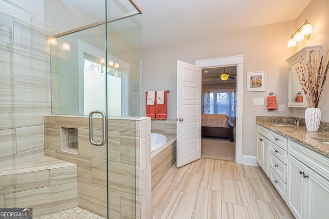 bathroom featuring ceiling fan, a healthy amount of sunlight, independent shower and bath, and vanity