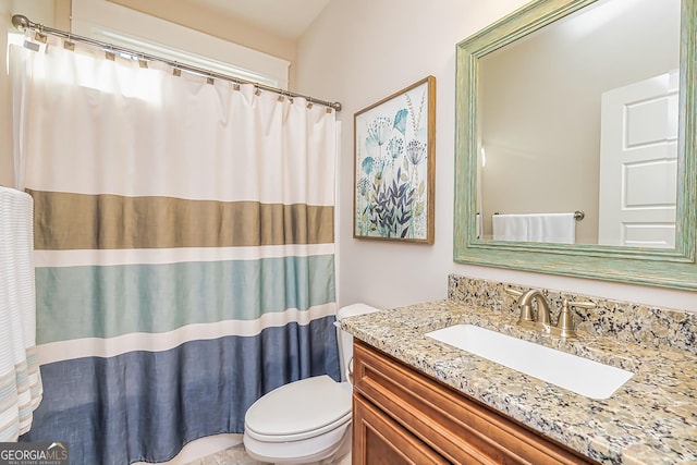 bathroom with vanity and toilet