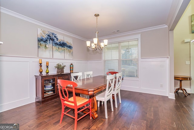 dining space featuring dark hardwood / wood-style floors, ornamental molding, and a notable chandelier