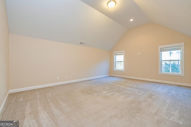 bonus room featuring light carpet and lofted ceiling