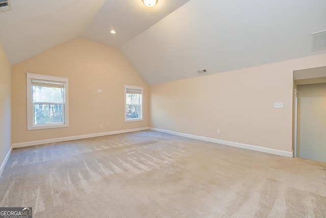 bonus room featuring light colored carpet and vaulted ceiling