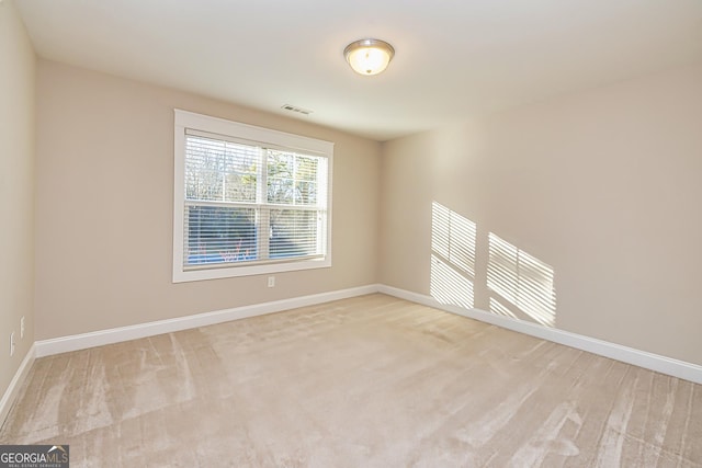 unfurnished room featuring light colored carpet