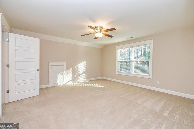 unfurnished room with light carpet, ceiling fan, and lofted ceiling