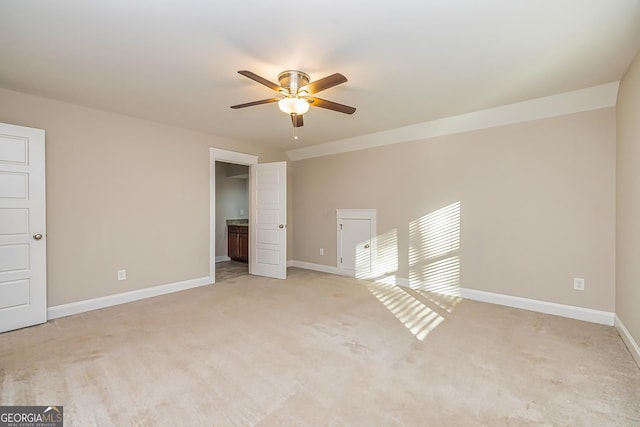 empty room featuring light carpet and ceiling fan