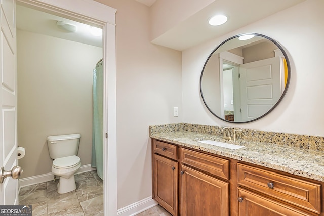 bathroom featuring vanity and toilet