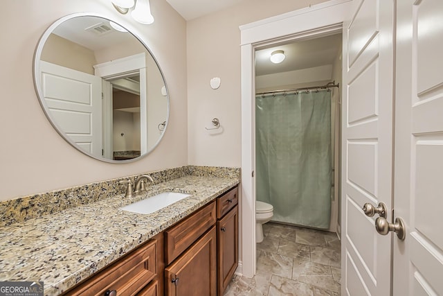 bathroom with vanity, toilet, and curtained shower