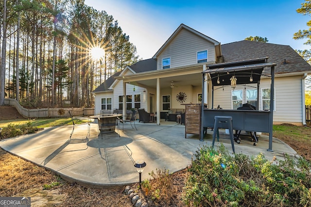 rear view of property with a patio area, exterior bar, and an outdoor hangout area