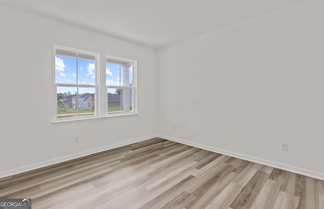 unfurnished room featuring wood finished floors and baseboards