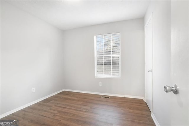 spare room featuring dark hardwood / wood-style floors