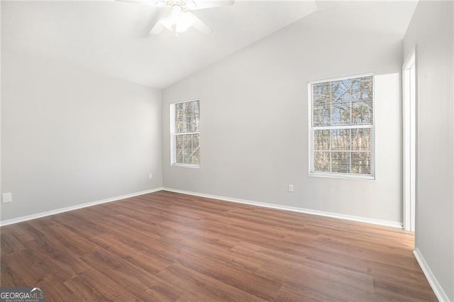 spare room with hardwood / wood-style floors, ceiling fan, and vaulted ceiling