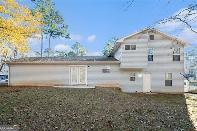 rear view of house with a lawn and french doors