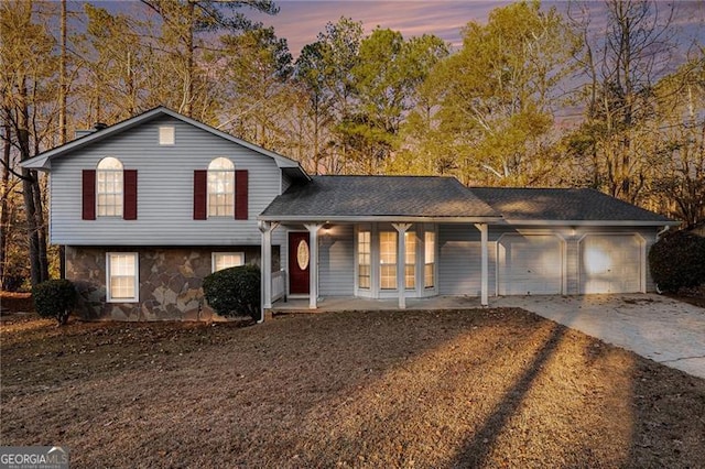 view of front of home featuring covered porch and a garage