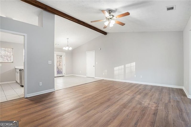 unfurnished room featuring lofted ceiling with beams, light hardwood / wood-style floors, and ceiling fan with notable chandelier