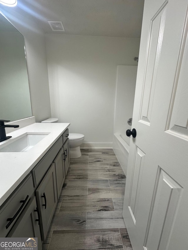 full bathroom featuring vanity, toilet, and shower / bathtub combination