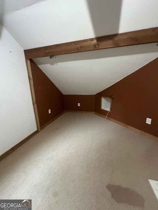 bonus room with carpet and vaulted ceiling