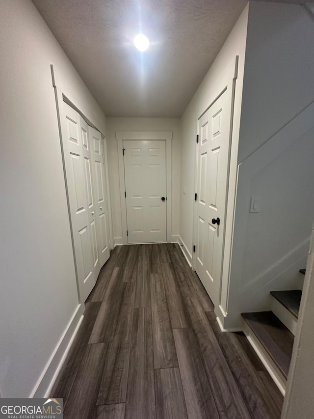 hall with dark hardwood / wood-style flooring