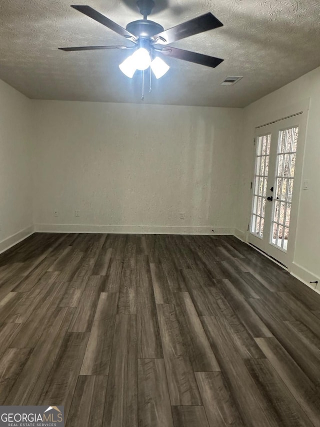 spare room with french doors, dark hardwood / wood-style flooring, a textured ceiling, and ceiling fan