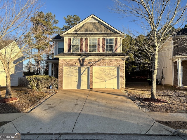 traditional-style home featuring driveway, a garage, and brick siding