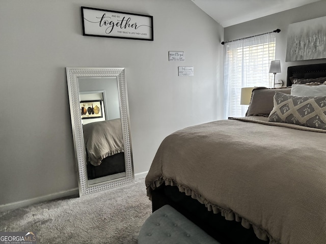 bedroom featuring carpet floors, baseboards, and lofted ceiling