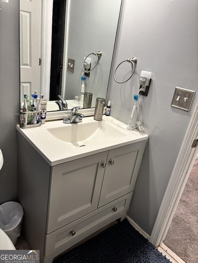 bathroom featuring vanity and toilet