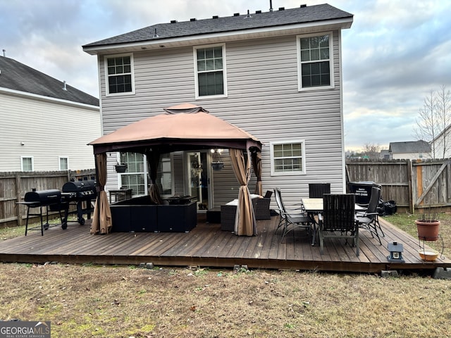 back of house with outdoor lounge area, a fenced backyard, outdoor dining area, and a gazebo