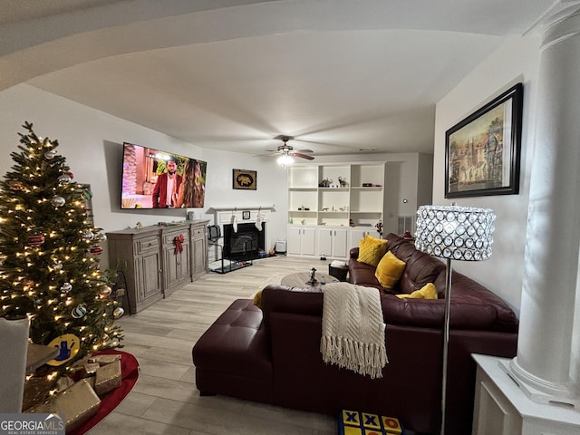 living room featuring ceiling fan and light wood-type flooring