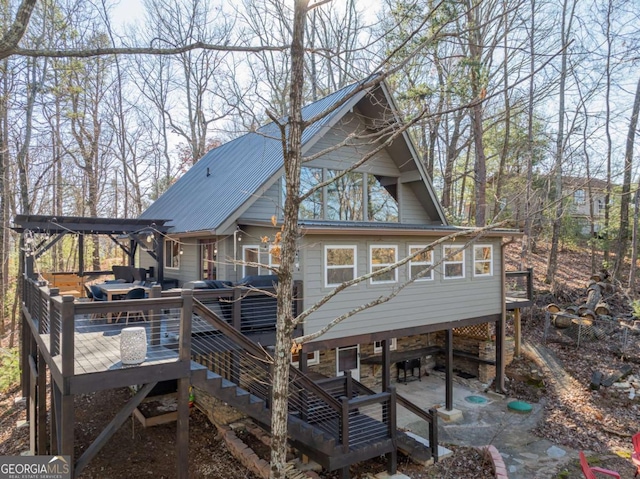 rear view of house featuring a patio and a deck