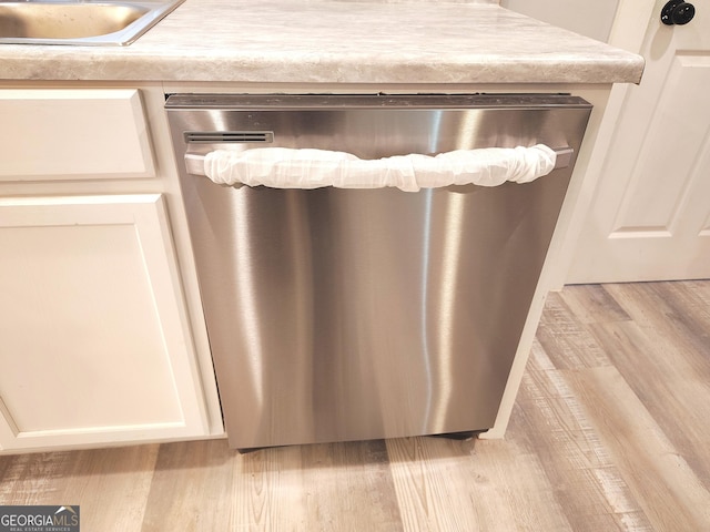 details featuring dishwasher, light hardwood / wood-style floors, and sink