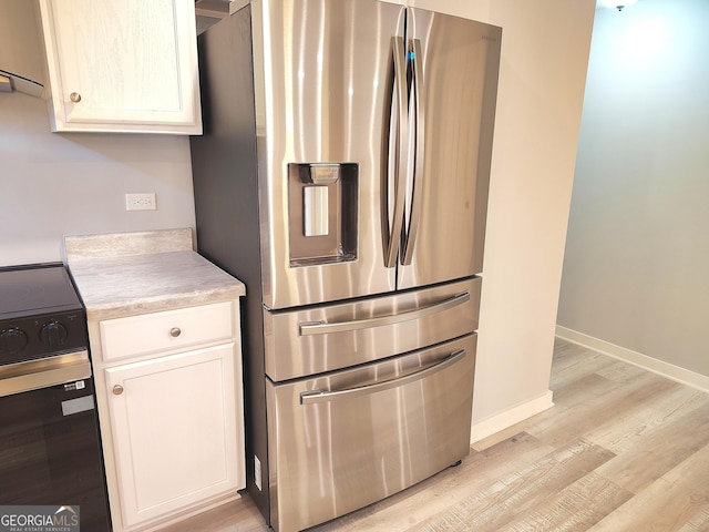 kitchen featuring black range with electric stovetop, white cabinetry, light hardwood / wood-style flooring, and stainless steel refrigerator with ice dispenser