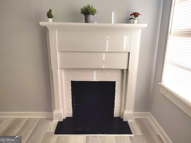 room details featuring a fireplace and hardwood / wood-style flooring