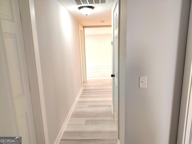 hallway with light hardwood / wood-style flooring