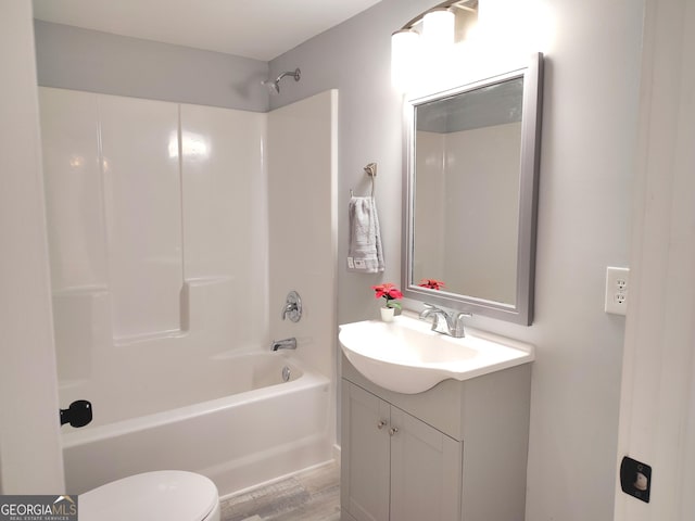 full bathroom with hardwood / wood-style floors, vanity, toilet, and shower / bath combination