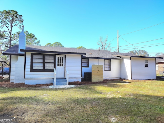 back of house with a lawn