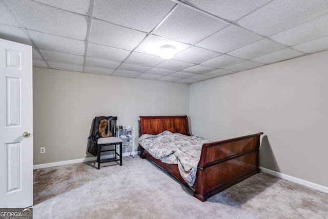 carpeted bedroom with a drop ceiling