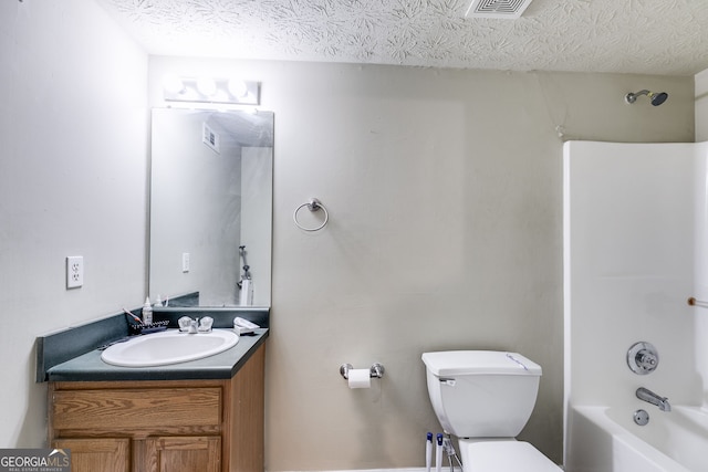 full bathroom with vanity, shower / bath combination, a textured ceiling, and toilet