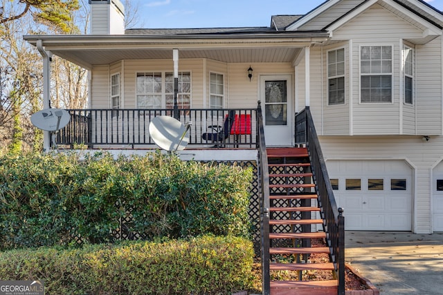 view of front of property featuring covered porch and a garage