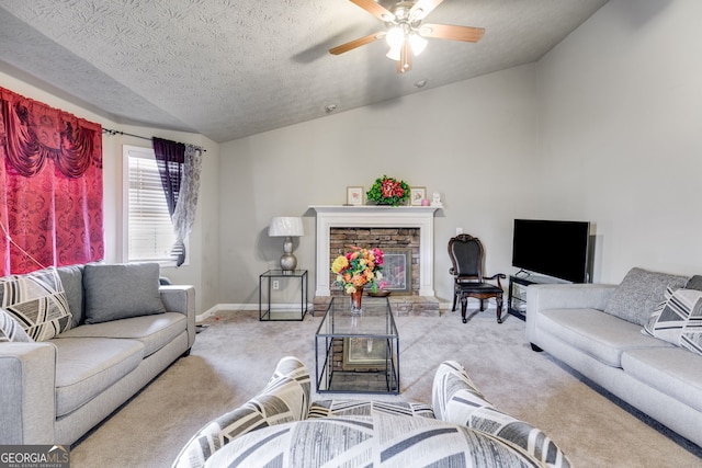 living room featuring lofted ceiling, ceiling fan, a fireplace, a textured ceiling, and light colored carpet