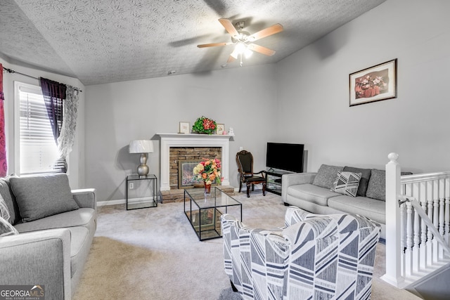 living room with vaulted ceiling, a fireplace, light colored carpet, and a textured ceiling