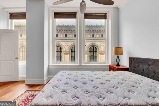 bedroom with light wood-type flooring and multiple windows