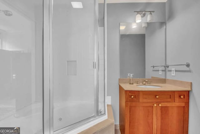 bathroom with vanity and a shower with shower door