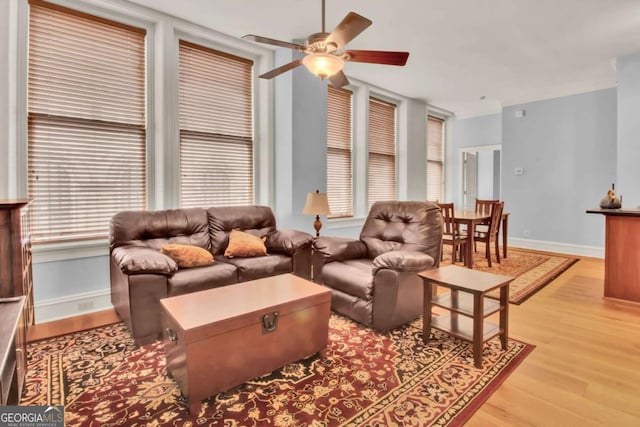 living room featuring ceiling fan and light hardwood / wood-style floors