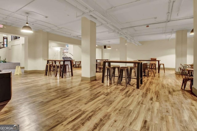 dining space featuring bar area and light hardwood / wood-style floors