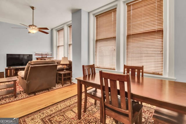 dining area with ceiling fan and wood-type flooring