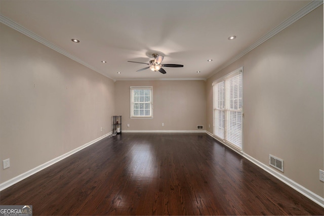 spare room featuring plenty of natural light, ornamental molding, dark hardwood / wood-style floors, and ceiling fan