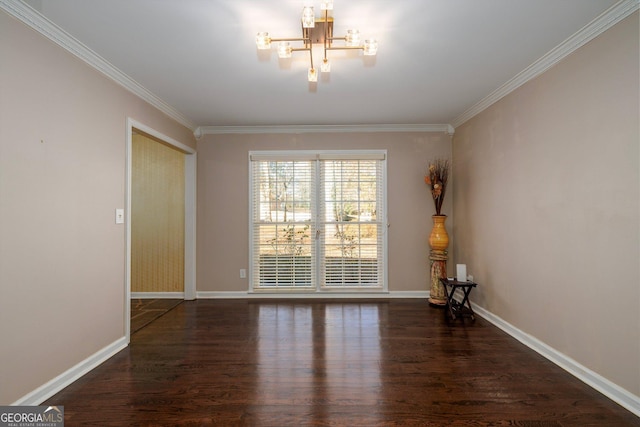 spare room featuring an inviting chandelier, dark hardwood / wood-style flooring, and ornamental molding