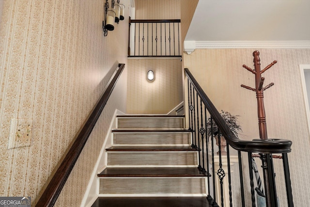 stairway featuring crown molding